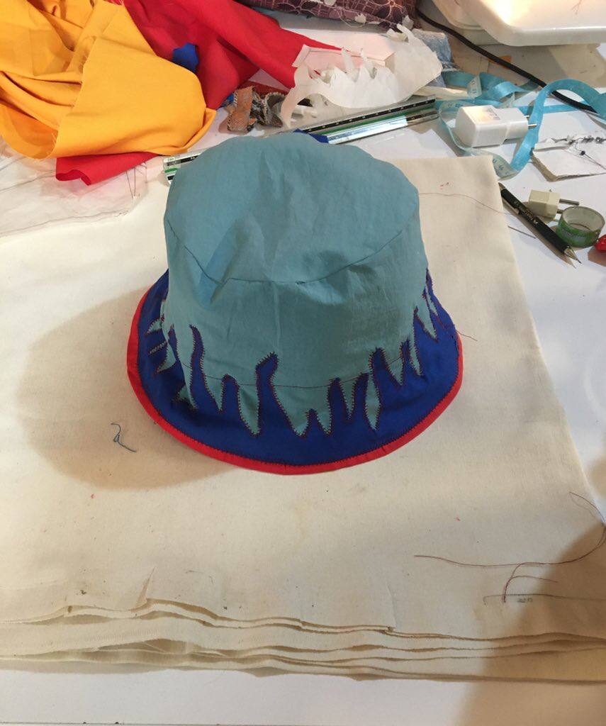 Teal bucket hat with drip applique in progress on the sewing table