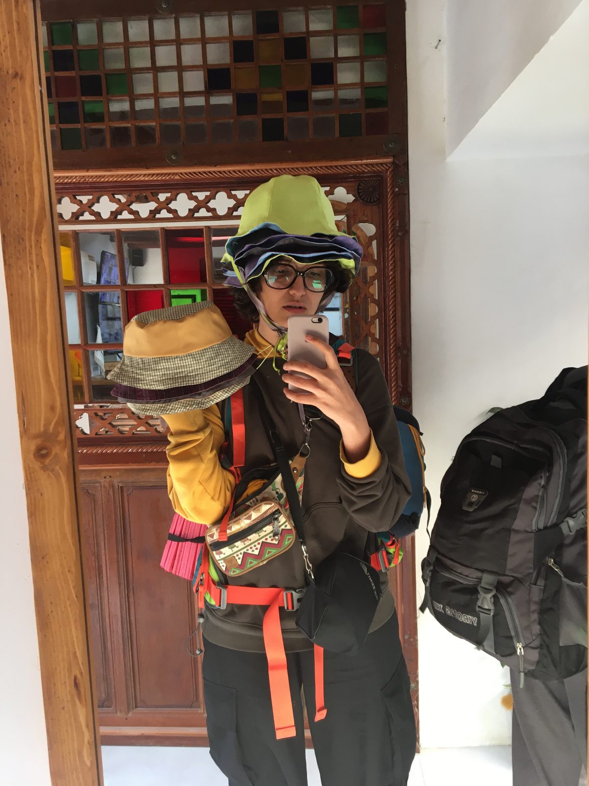 Second fitting shot with hats and orange straps in a traditional interior