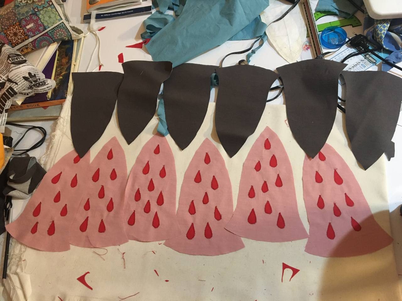 Brown and red petal applique pieces laid out on fabric