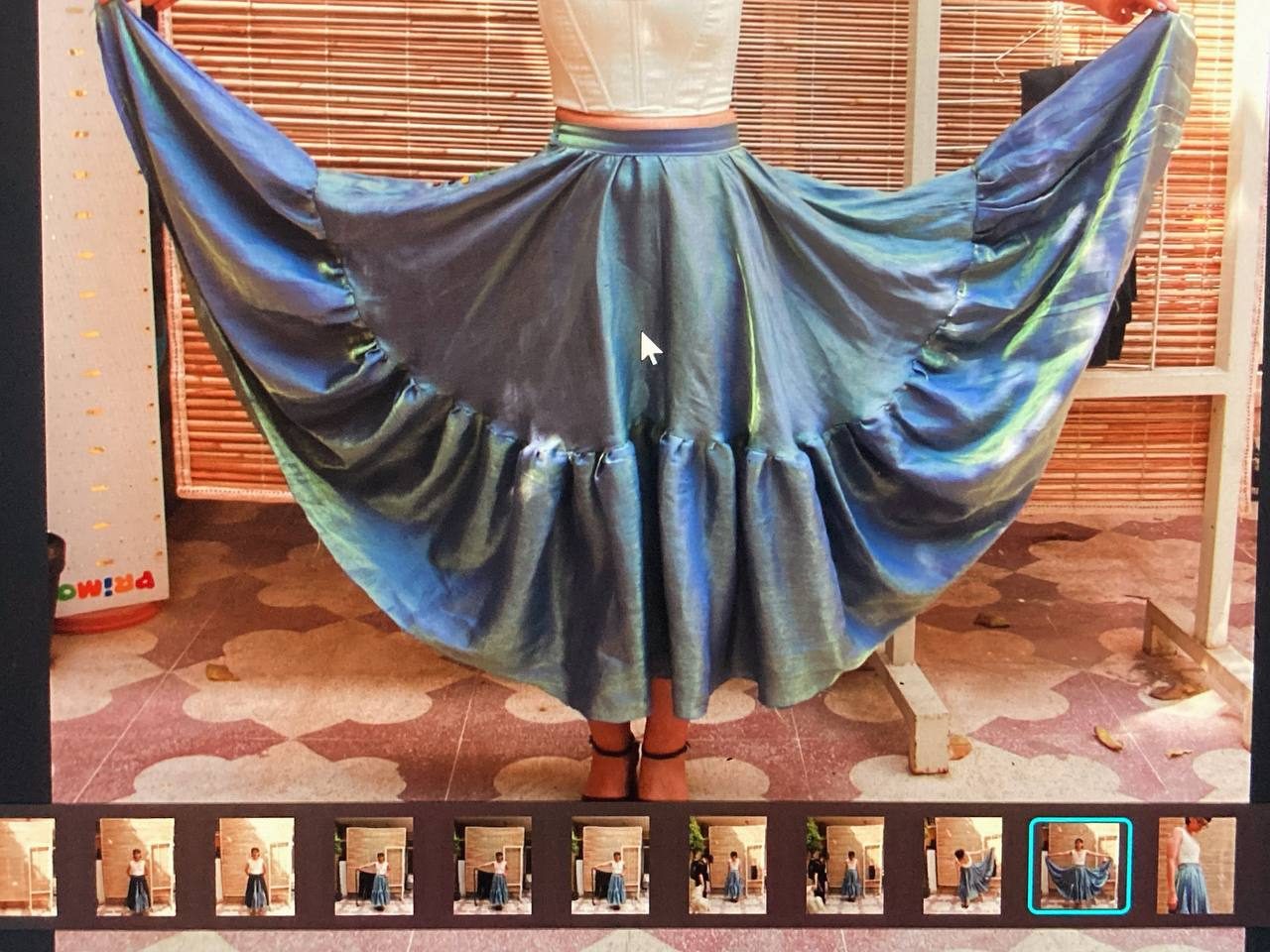 Blue iridescent circle skirt spread out to show its full width