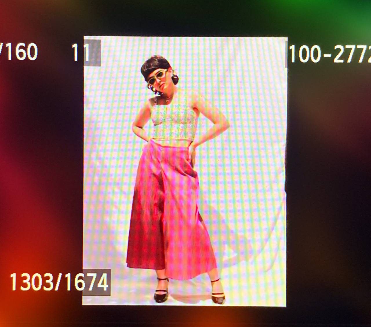 Model posing in the pink look with sunglasses