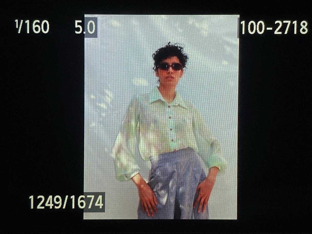 Model in an iridescent shirt and lavender trousers