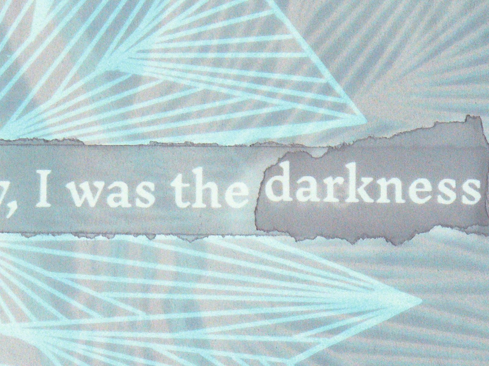 Torn text reading I was the darkness across a light blue page