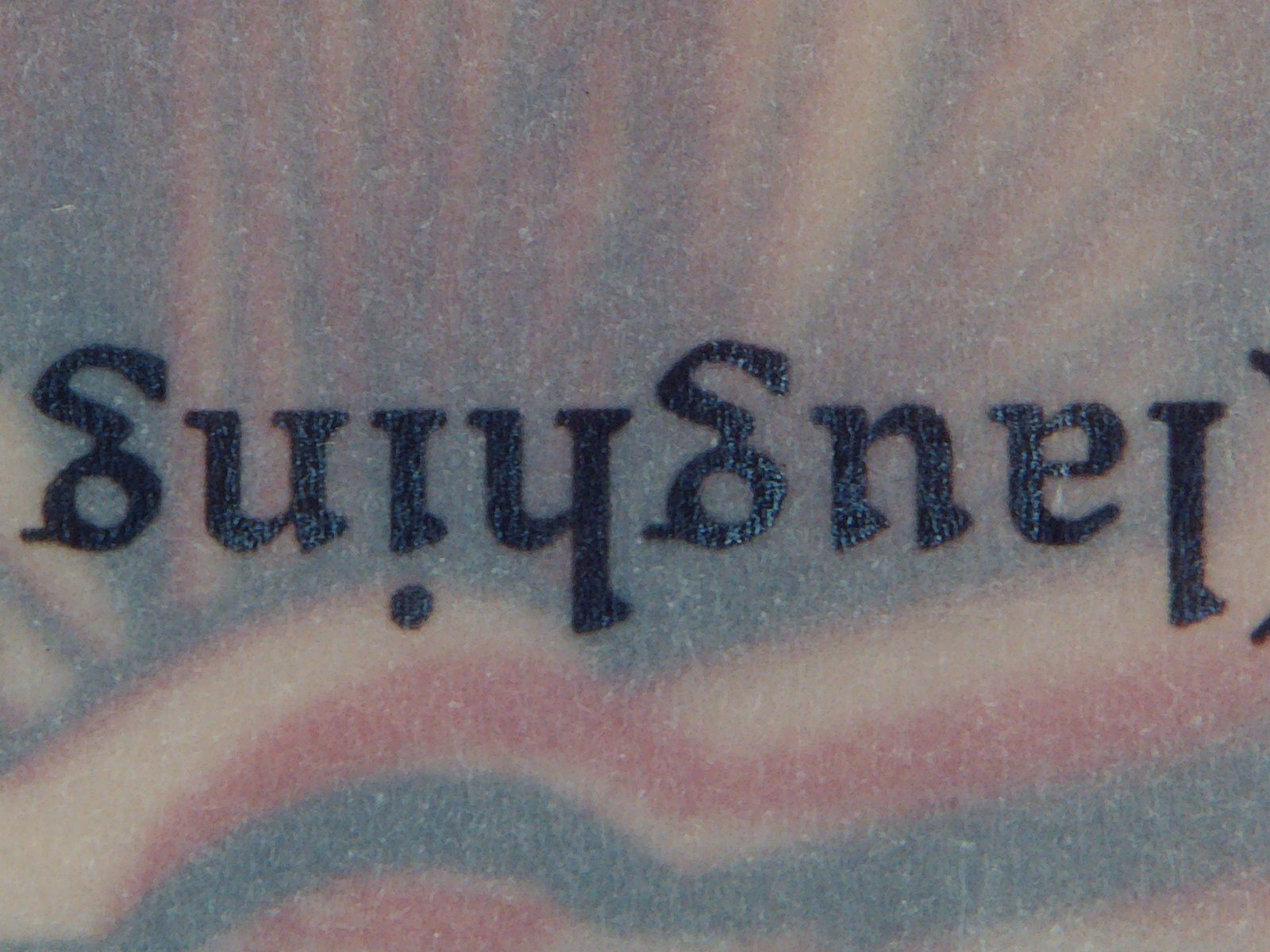 Page detail with the word laughing showing through the paper