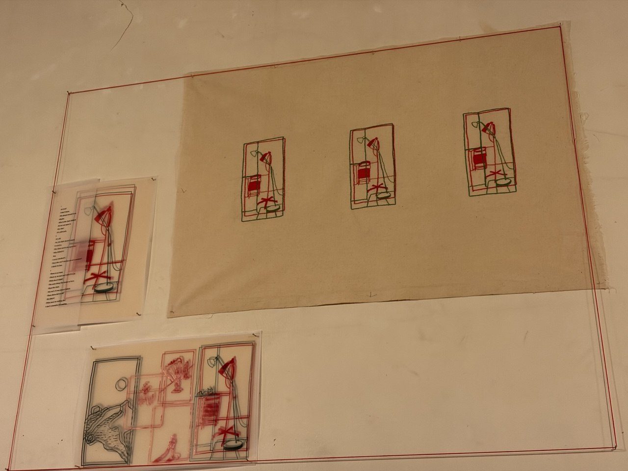 Small stitched drawings arranged flat on beige paper
